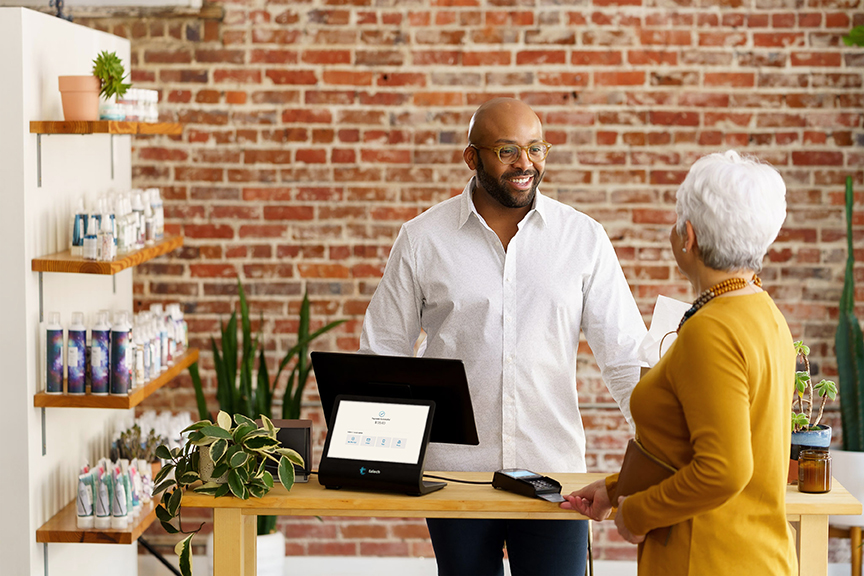 Woman paying for items at a hair salon