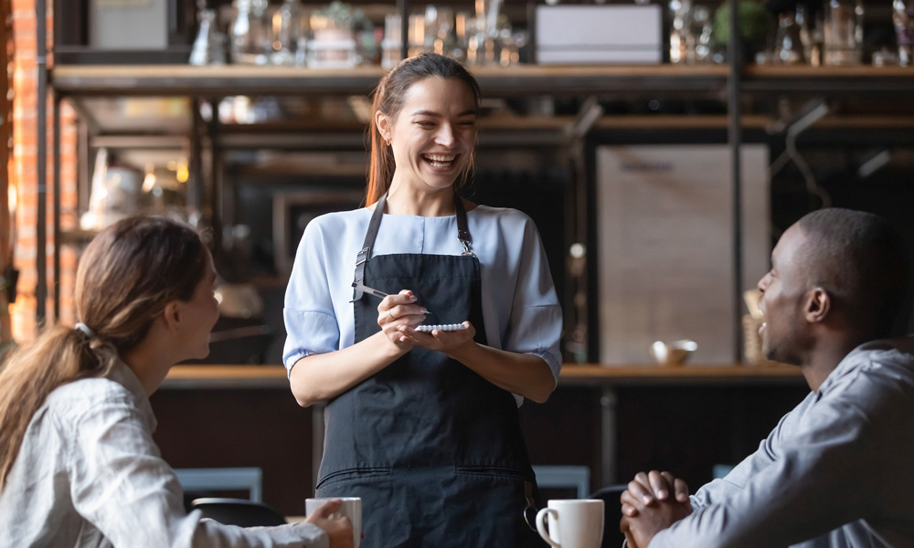 Waitress taking a couples order in a restaurant